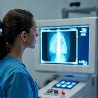 Veterinary nurse operating digital X-ray scanner